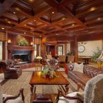 wood paneled ceiling and fireplace in living room