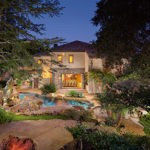 expansive backyard with pool, rock waterfall and landscape