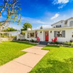 Eastside Costa Mesa home front view white house with red door