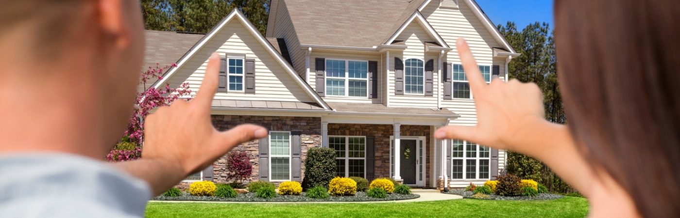 home in view of person holding up their hands to look at the house