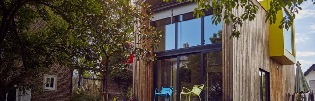 Exterior of large home with glass doors and windows