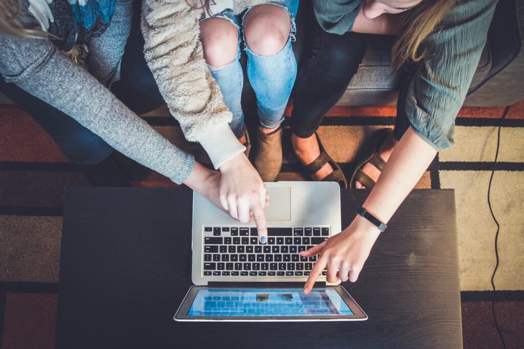 group gathered around a laptop