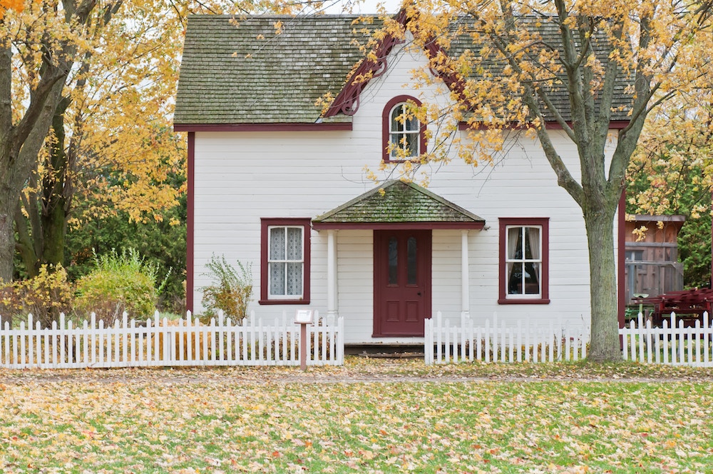 white house under maple trees Small house on an autumn’s day