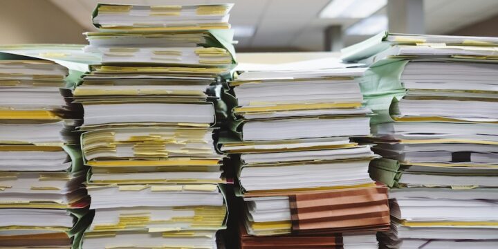 stack of papers and documents organized into folders