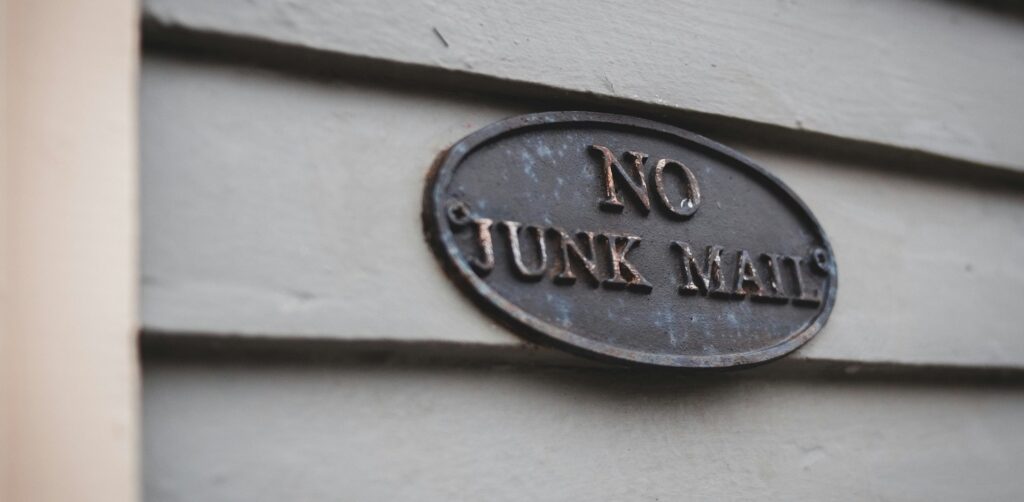 sign that says "no junk mail" on a door