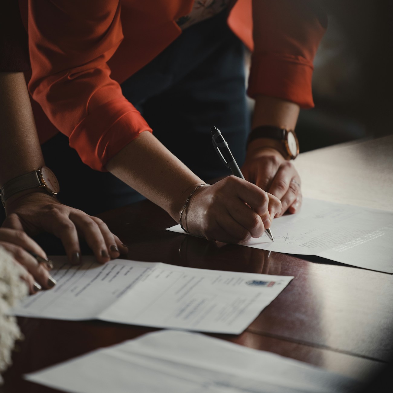 people signing a document