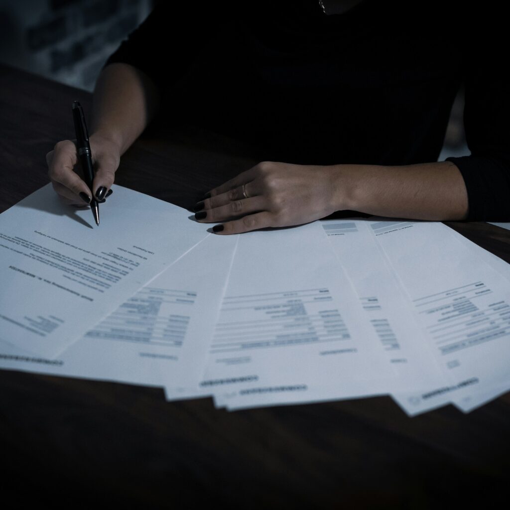 paperwork with person completing by hand