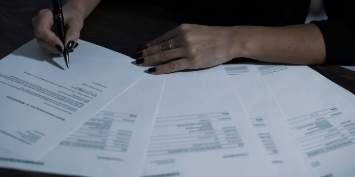 paperwork with person completing by hand