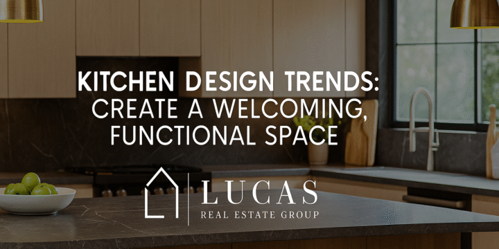 Modern kitchen interior featuring a marble island, brass pendant lights, sleek neutral cabinetry, and natural wood accents, with the Lucas Real Estate Group logo and the title "Kitchen Design Trends: Create a Welcoming, Functional Space" centered on the image.