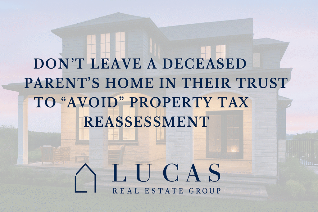 Promotional graphic for Lucas Real Estate Group featuring a luxury coastal-style home in the background with the text: “Don’t leave a deceased parent’s home in their trust to ‘avoid’ property tax reassessment.” The Lucas Real Estate Group logo is centered at the bottom. The design is professional, with a soft overlay for text clarity and ample spacing around the edges.