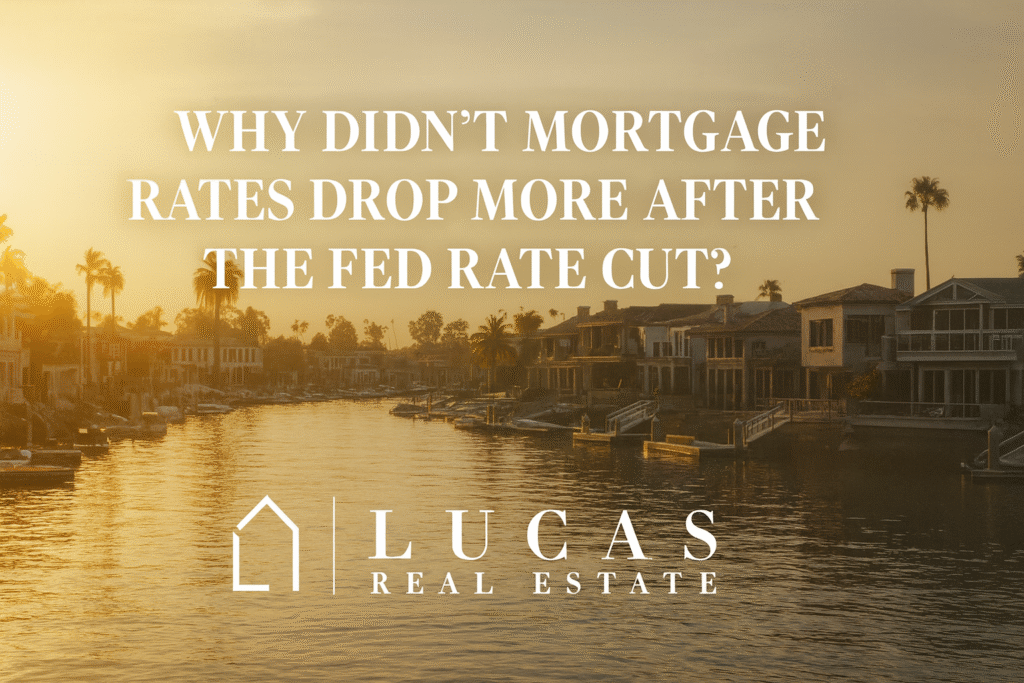 lassy waterfront scene at sunset with luxurious homes reflecting on calm water. The text reads, “Why Didn’t Mortgage Rates Drop More After the Fed Rate Cut?” with the Lucas Real Estate logo centered below, maintaining a professional and high-end aesthetic.